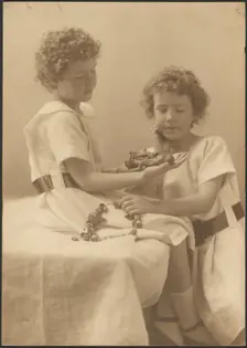 Portrait of Two Sisters Holding Statue and Wreath, 1907-1943. Creator: Louis Fleckenstein