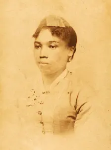 Portrait of unidentified young woman wearing ribbon on head, c1880-c1889. Creator: JW Perkins