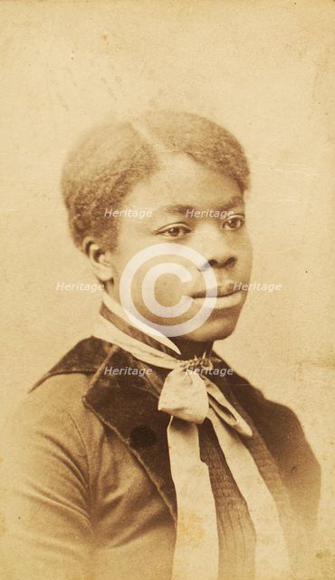Portrait of young woman with velvet lapels and ribbon bow around neck, (1880-1889?). Creator: LV Bean.