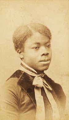 Portrait of young woman with velvet lapels and ribbon bow around neck, (1880-1889?). Creator: LV Bean