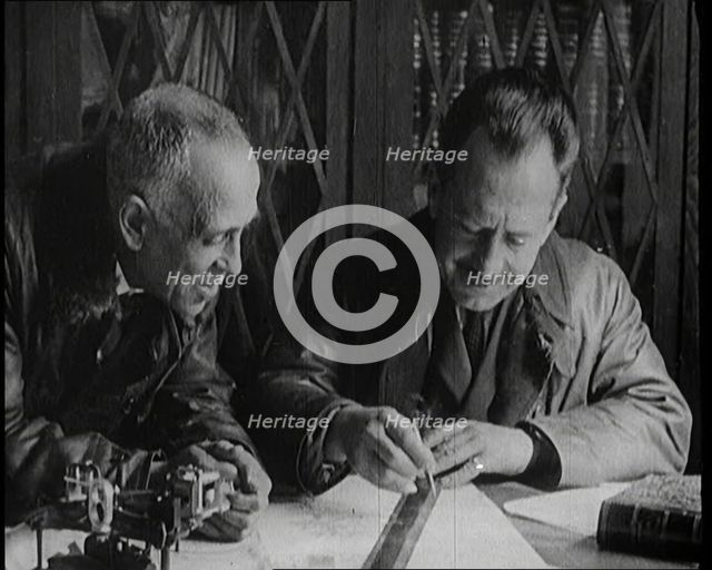 Portuguese Airmen Sacadura Cabral and Gago Coutinho Looking at a Map, 1922. Creator: British Pathe Ltd.