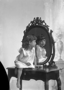 Posed portrait of a girl by a mirror, Landskrona, Sweden, 1910. Creator: Unknown