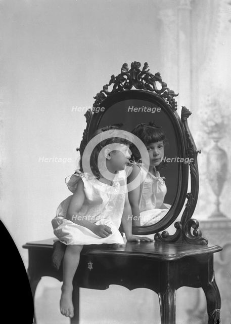 Posed portrait of a girl by a mirror, Landskrona, Sweden, 1910. Creator: Unknown.