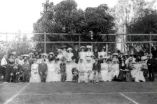 Possibly City Electric Light company employees and their families on a tennis court, 1903. Creator: Robert Augustus Henry L'Estrange
