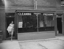 Possibly: A tailor in Frank's cleaning and pressing establishment checking..., Washington, DC, 1942. Creator: Gordon Parks