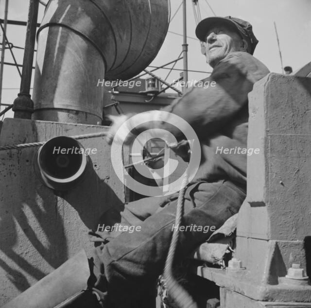 Possibly: A hoister unloading fish at Fulton fish market, New York, 1943. Creator: Gordon Parks.