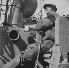 Possibly: A hoister unloading fish at Fulton fish market, New York, 1943. Creator: Gordon Parks