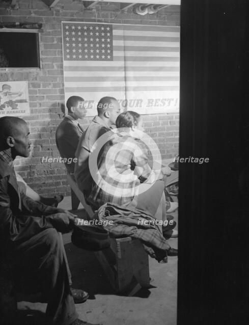 Possibly: Air raid wardens' meeting in zone nine, Southwest area, Washington, D.C., 1942. Creator: Gordon Parks.