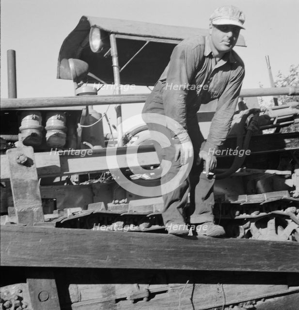 Possibly: Bulldozer raises and pushes stump on cut-over farm, Lewis County, Western Washington, 1939 Creator: Dorothea Lange.