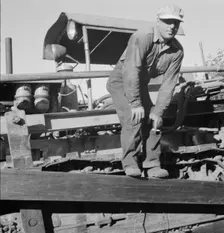 Possibly: Bulldozer raises and pushes stump on cut-over farm, Lewis County, Western Washington, 1939 Creator: Dorothea Lange