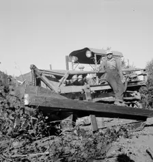 Possibly: Bulldozer raises and pushes stump on cut-over farm, Lewis County, Western Washington, 1939 Creator: Dorothea Lange