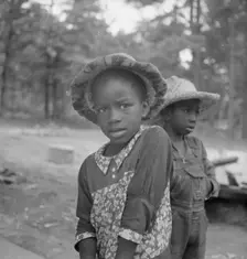 Possibly: Grandchildren of tobacco sharecropper down at barns, Wake County, North Carolina, 1939. Creator: Dorothea Lange