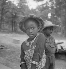 Possibly: Grandchildren of tobacco sharecropper down at barns, Wake County, North Carolina, 1939. Creator: Dorothea Lange