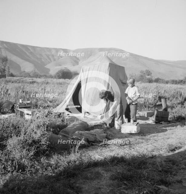 Possibly: Fatherless migratory family camped behind gas station, Yakima Valley, Washington, 1939. Creator: Dorothea Lange.