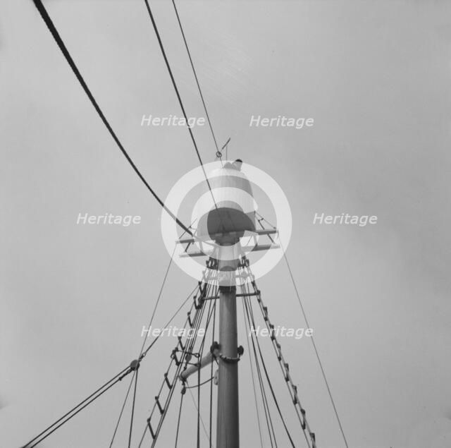 Possibly: Frank Mineo, owner of the Alden, climbs to the crow's..., Gloucester, Massachusetts], 1943 Creator: Gordon Parks.