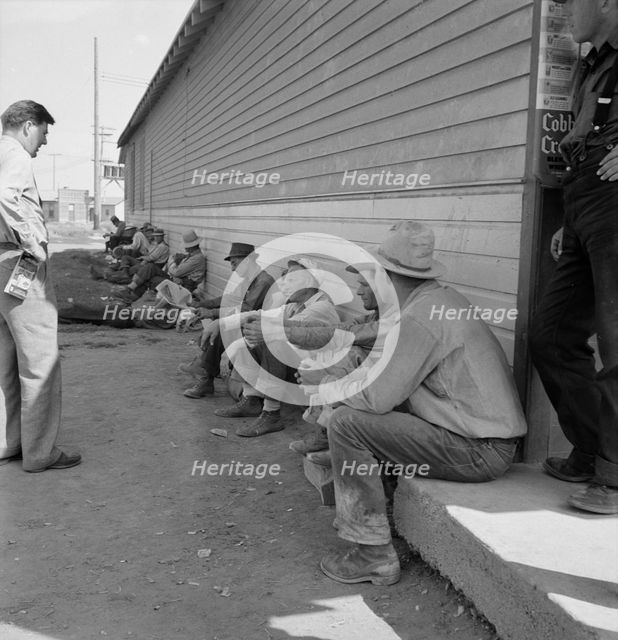 Possibly: Idle men seated in shade on the other side..., Tulelake, Siskiyou County, California, 1939 Creator: Dorothea Lange.