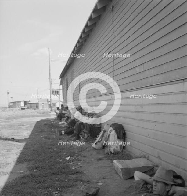 Possibly: Idle men seated in shade on the other side..., Tulelake, Siskiyou County, California, 1939 Creator: Dorothea Lange.