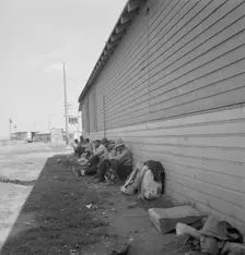 Possibly: Idle men seated in shade on the other side..., Tulelake, Siskiyou County, California, 1939 Creator: Dorothea Lange