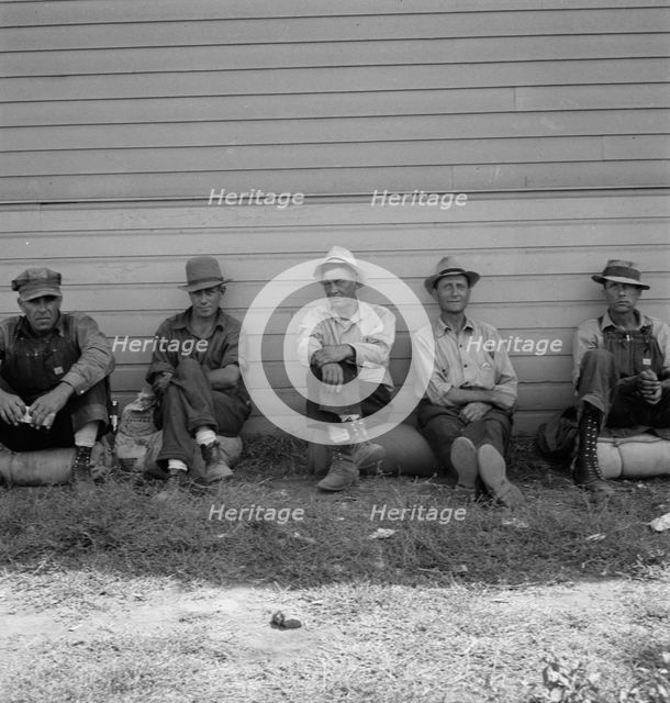 Possibly: Idle men seated in shade on the other side..., Tulelake, Siskiyou County, California, 1939 Creator: Dorothea Lange.