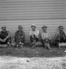 Possibly: Idle men seated in shade on the other side..., Tulelake, Siskiyou County, California, 1939 Creator: Dorothea Lange
