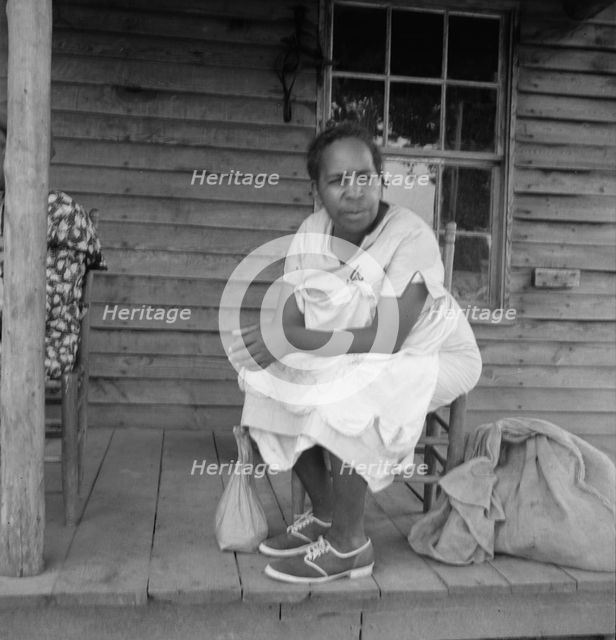 Possibly: Mother of sharecropper family and friend...the rain, Person County, North Carolina, 1939. Creator: Dorothea Lange.