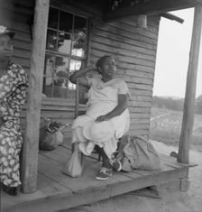 Possibly: Mother of sharecropper family and friend...the rain, Person County, North Carolina, 1939. Creator: Dorothea Lange