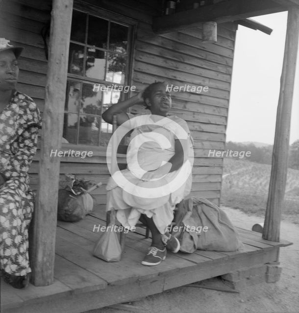 Possibly: Mother of sharecropper family and friend...the rain, Person County, North Carolina, 1939. Creator: Dorothea Lange.