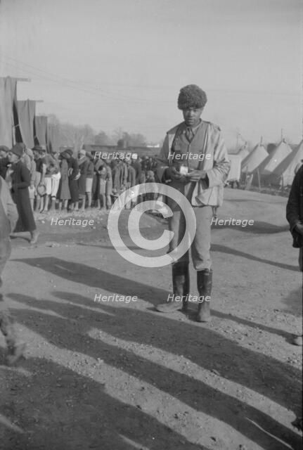 Possibly: Negro with a fur cap, a flood refugee in the camp at Forrest City, Arkansas, 1937. Creator: Walker Evans.