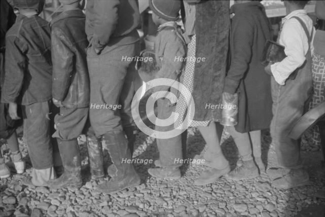 Possibly: Negroes at mealtime in the flood refugee camp, Forrest City, Arkansas, 1937. Creator: Walker Evans.