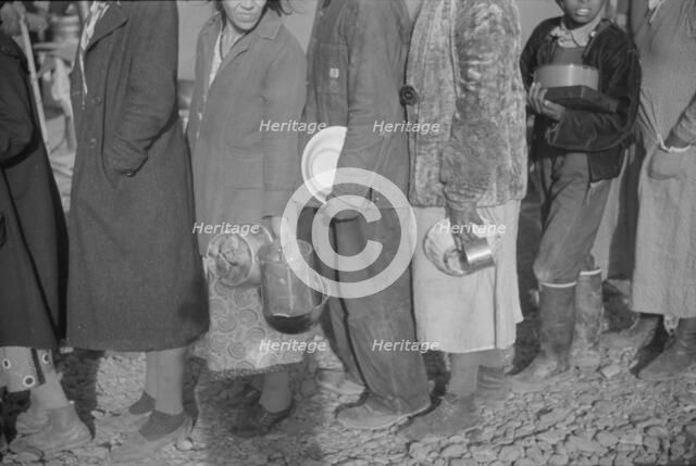 Possibly: Negroes at mealtime in the flood refugee camp, Forrest City, Arkansas, 1937. Creator: Walker Evans.