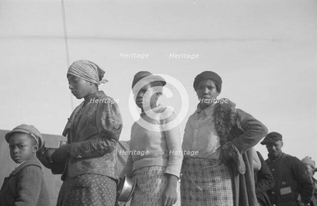 Possibly: Negroes in the lineup for food at meal time in the camp..., Forrest City, Arkansas, 1937. Creator: Walker Evans.