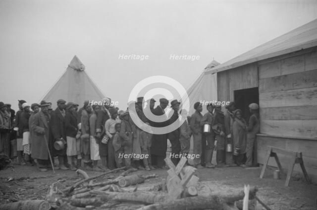 Possibly: Negroes in the lineup for food at meal time in the camp..., Forrest City, Arkansas, 1937. Creator: Walker Evans.