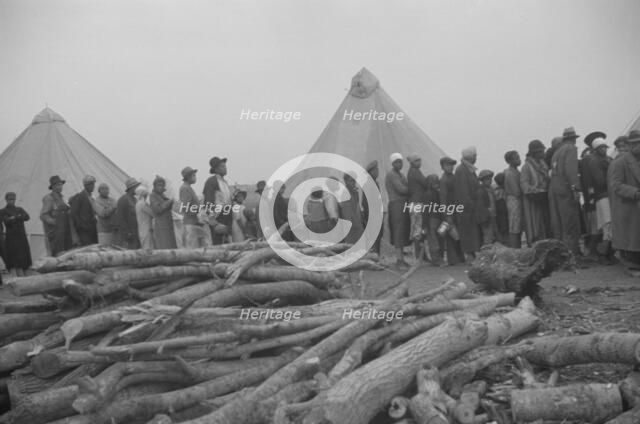 Possibly: Negroes in the lineup for food at meal time in the camp..., Forrest City, Arkansas, 1937. Creator: Walker Evans.