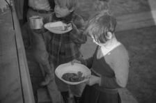 Possibly: Negroes in the lineup for food at mealtime in the camp..., Forrest City, Arkansas, 1937. Creator: Walker Evans