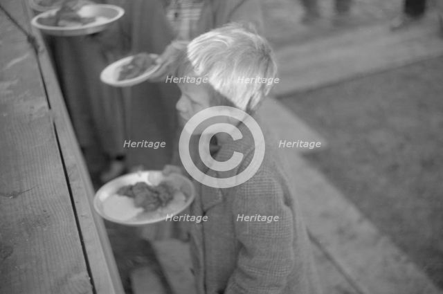 Possibly: Negroes in the lineup for food at mealtime in the camp..., Forrest City, Arkansas, 1937. Creator: Walker Evans.