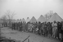 Possibly: Negroes in the lineup for food at mealtime in the camp..., Forrest City, Arkansas, 1937. Creator: Walker Evans