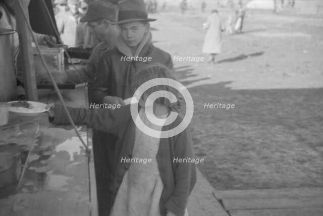 Possibly: Negroes in the lineup for food at mealtime in the camp..., Forrest City, Arkansas, 1937. Creator: Walker Evans.