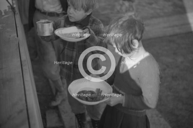 Possibly: Negroes in the lineup for food at mealtime in the camp..., Forrest City, Arkansas, 1937. Creator: Walker Evans.