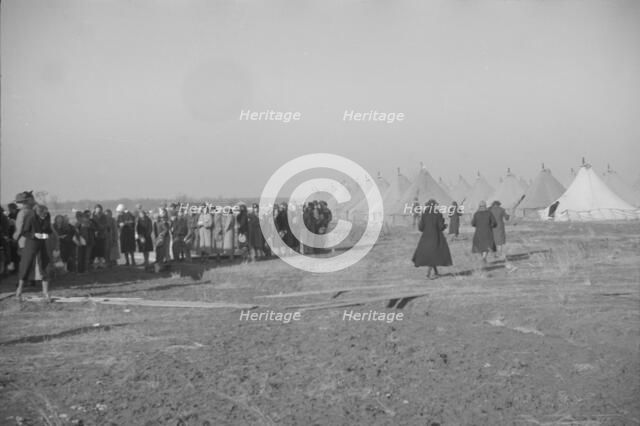 Possibly: Negroes in the lineup for food at mealtime in the camp..., Forrest City, Arkansas, 1937. Creator: Walker Evans.