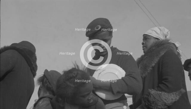 Possibly: Negroes in the lineup for food at mealtime in the camp..., Forrest City, Arkansas, 1937. Creator: Walker Evans.