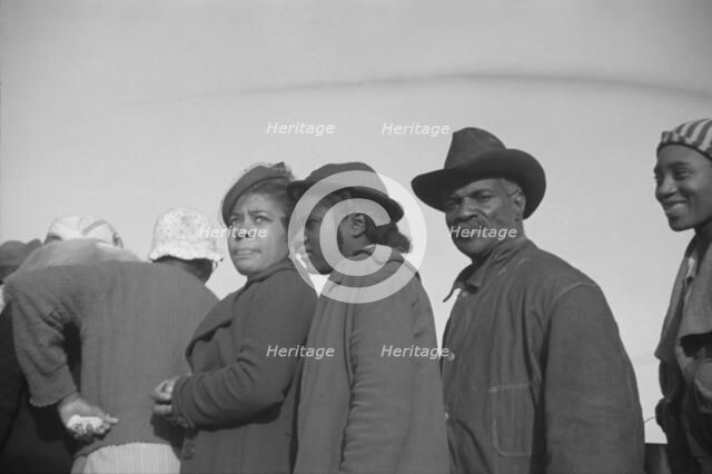 Possibly: Negroes in the lineup for food at mealtime in the camp..., Forrest City, Arkansas, 1937. Creator: Walker Evans.