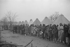 Possibly: Negroes in the lineup for food at mealtime in the camp..., Forrest City, Arkansas, 1937. Creator: Walker Evans