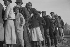 Possibly: Negroes in the lineup for food at the flood refugee camp, Forrest City, Arkansas, 1937. Creator: Walker Evans