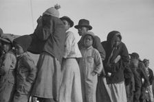 Possibly: Negroes in the lineup for food at the flood refugee camp, Forrest City, Arkansas, 1937. Creator: Walker Evans