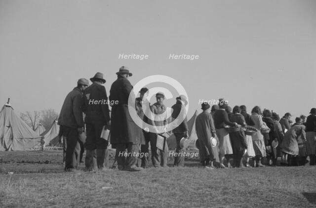 Possibly: Negroes in the lineup for food at the flood refugee camp, Forrest City, Arkansas, 1937. Creator: Walker Evans.