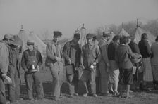 Possibly: Negroes in the lineup for food at the flood refugee camp, Forrest City, Arkansas, 1937. Creator: Walker Evans