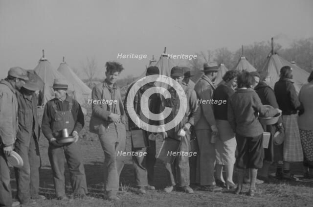 Possibly: Negroes in the lineup for food at the flood refugee camp, Forrest City, Arkansas, 1937. Creator: Walker Evans.