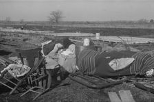Possibly: Setting up a tent in the camp for white flood refugees, Forrest City, Arkansas, 1937. Creator: Walker Evans