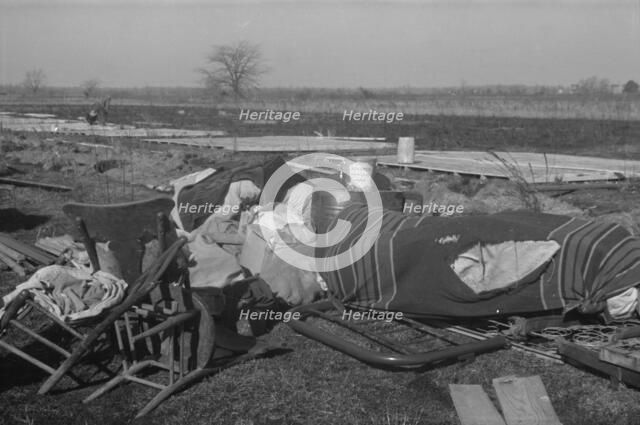 Possibly: Setting up a tent in the camp for white flood refugees, Forrest City, Arkansas, 1937. Creator: Walker Evans.