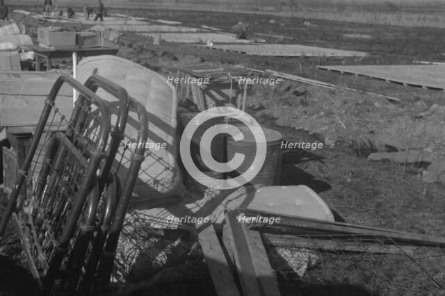 Possibly: Setting up a tent in the camp for white flood refugees, Forrest City, Arkansas, 1937. Creator: Walker Evans.